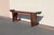 A striking 19th-century Chinese console table, featuring a long, narrow silhouette with elegantly everted, flaring ends—an...