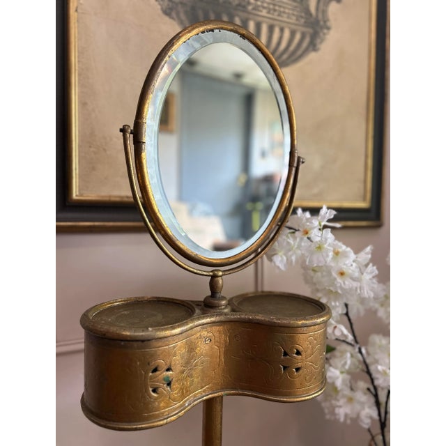 Antique Victorian gentleman’s shaving stand in gilt metal, featuring an adjustable oval mirror above a fitted top with...