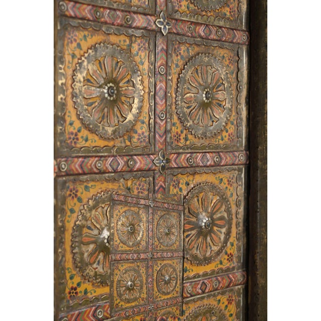 Antique Indian Painted Teakwood and Brass Door on Iron Stand, of exceptional quality and beauty, with a yellow/gold paint...