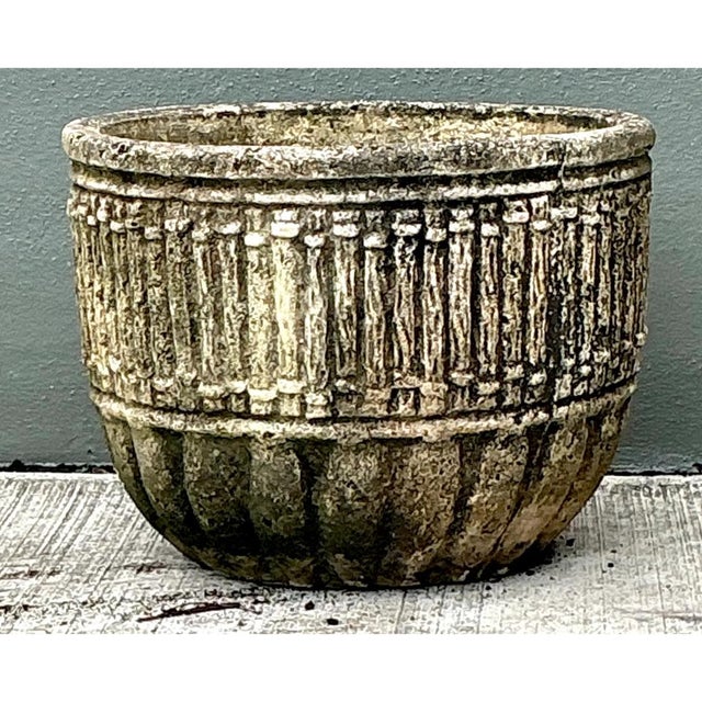 This vintage concrete fluted garden planter presents a broad, rounded bowl silhouette with a generous, slightly inturned...
