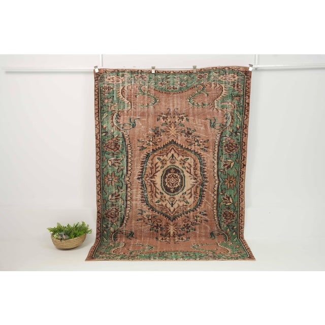 Vintage Hand-Knotted runner rug is a semi-antique vintage area rug. The '70s Eastern region of Anatolia's unique rug is...
