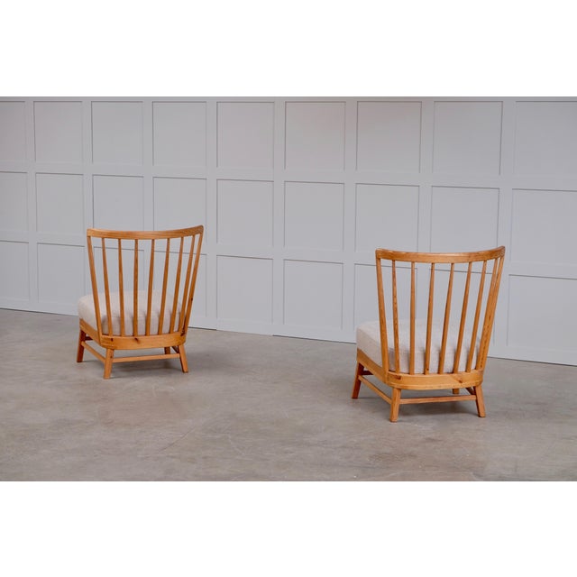 This is a beautiful and rare pair of Swedish easy chairs, produced early 1950s. They are made of pine and reupholstered...