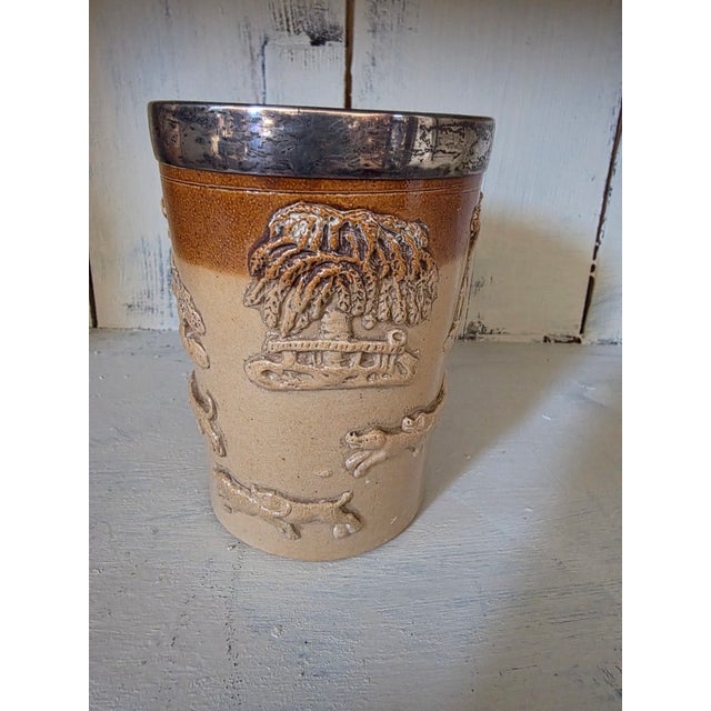 Charming antique English Doulton Lamberh sterling rimmed cup.