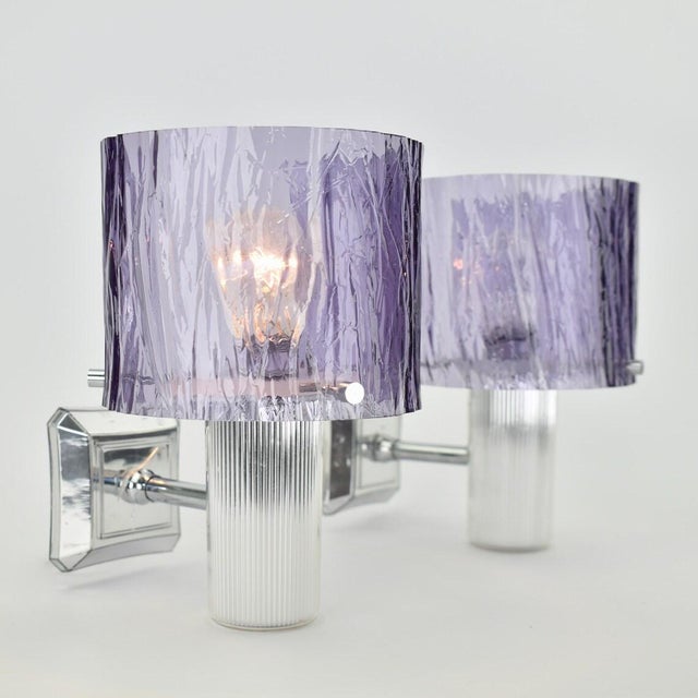 Stunning set of Amethyst colored Wall Sconces. Featuring shimmering chromed plastic fixtures and textured plastic "ice...