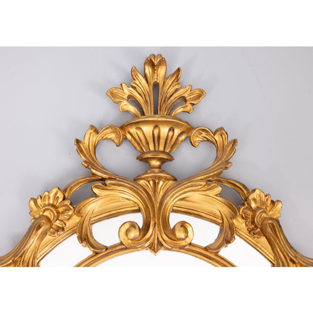 A stunning vintage Italian gilt resin round crested mirror. Marked "Italy" on reverse. This gorgeous mirror has an ornate...