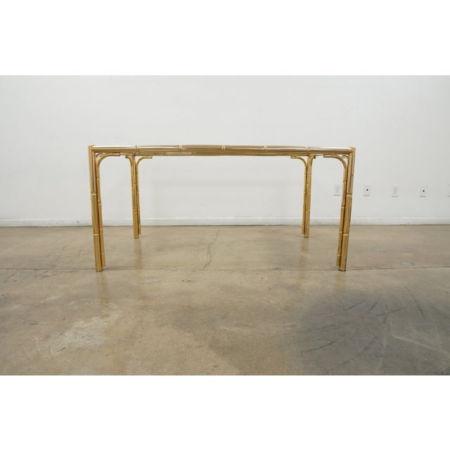 This vintage mid century dining table showcases a striking faux bamboo design, a hallmark of Hollywood Regency and mid-...
