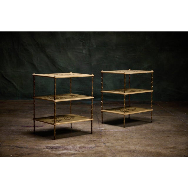 Maison Bagues pair of chinoiserie three-tier side tables with faux bamboo gilt metal legs and painted tole trays. The...