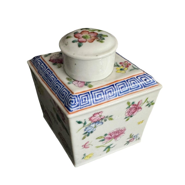 A gorgeous early 1900s footed porcelain tea caddy in the shape of a diamond. The top on caddy with a Greek key design in a...