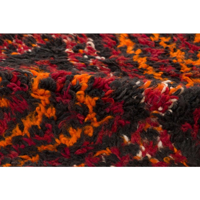 Hand-knotted in wool and originating circa 1950-1959, this 5x8 vintage Moroccan berber rug joins Rug & Kilim’s Moroccan...