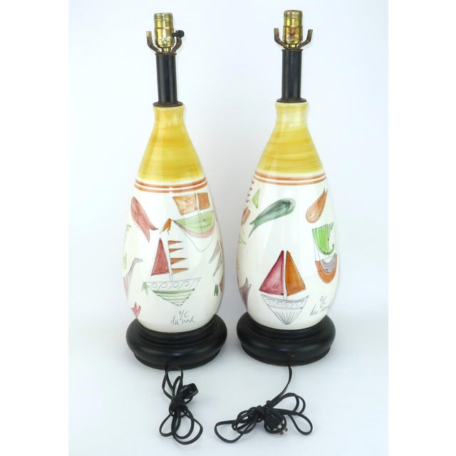 Ships ahoy! A pair of C.1960 ceramic table lamps signed 'ELC Du Nord' featuring Viking style ships and abstract sea life...