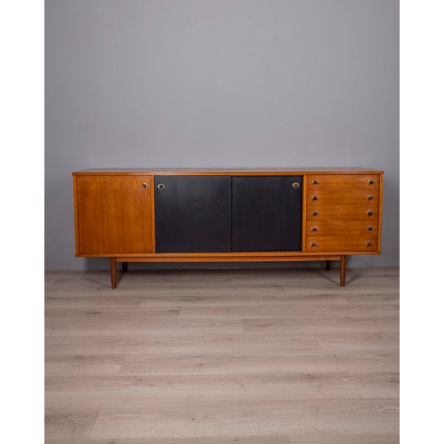 Teak wood sideboard with gold-plated brass inserts, the two central sliding doors are in black painted wood, Italian...