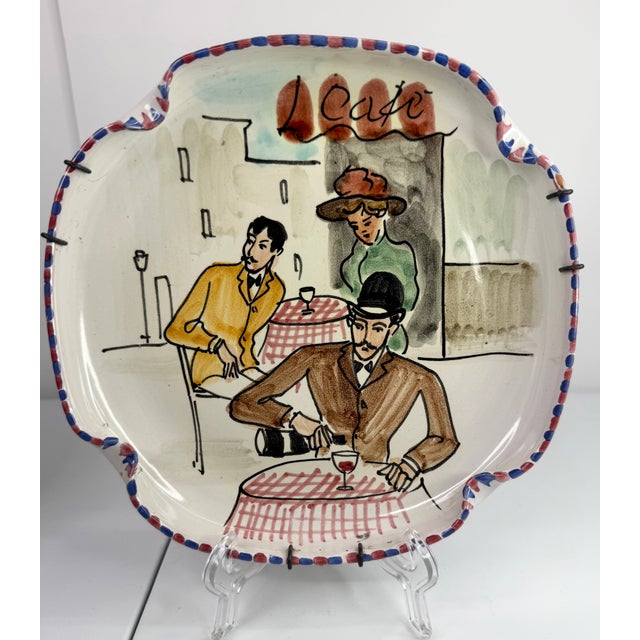 Colorful Italian cafe scene hand painted on clover shaped plates. Cafe scenes on both plates feature red checked table...