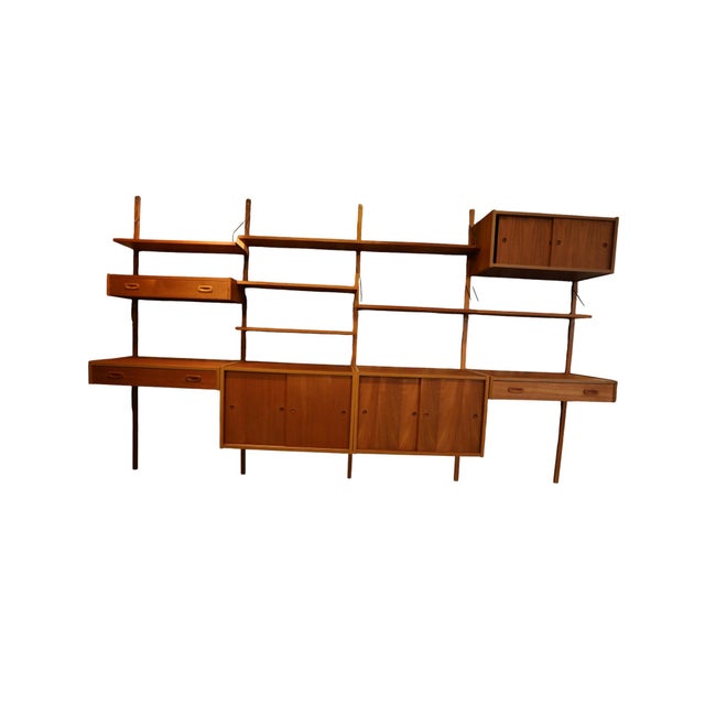 An exclusive and highly flexible wall-mounted shelving system in teak that combines timeless elegance with generous...