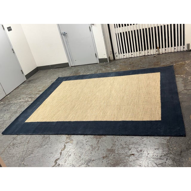Design Plus Gallery presents a 7ft11in × 10ft Classic Wool Border Rug from Pottery Barn Teen. This rectangular area rug is...