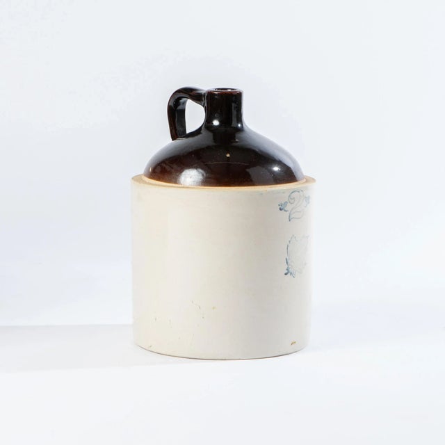 This is an antique Western Stoneware crock jug made in the early 1900's. The one gallon crock features a brown slip top...