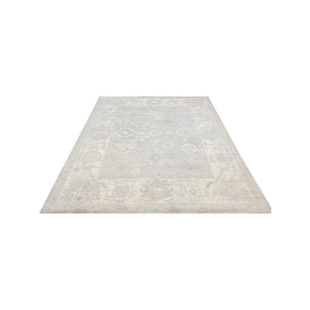 This exceptional 8x10 Oushak style area rug is a true luxury, showcasing Pakistani craftsmanship. Made from high-quality...