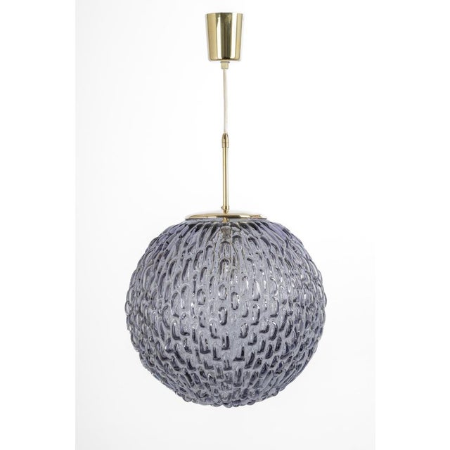 A large round with colored bubble glass pendant designed by helena tynell for limburg, manufactured in germany, circa the...