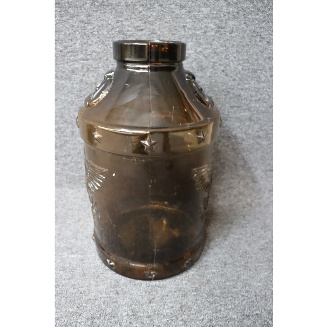 Amber glass jar with eagle accent.