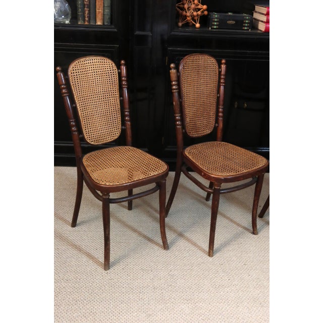 Set of four chairs by Thonet, early 20th century. These chairs have caned seats and backs. The caning and wood are in very...