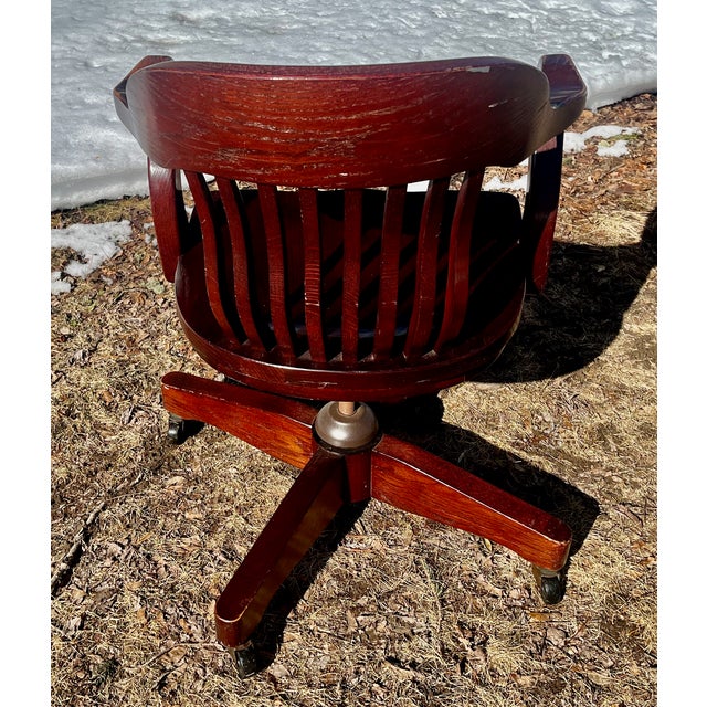 Enjoy the comfort and history of this 1940s, solid oak chair. It swivels, rocks and rolls on four casters. Has an 8 slats...
