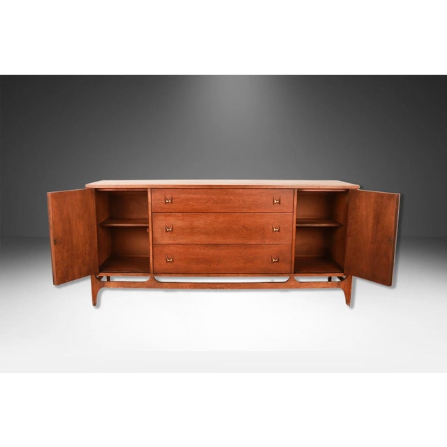 Vintage, circa early 1960s, Walnut credenza, dresser, this absolute jewel remains in nearly pristine condition. The...