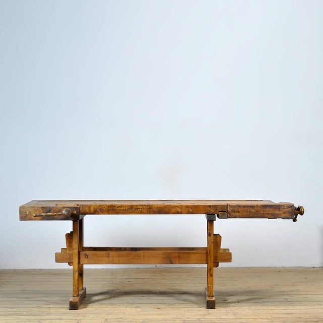 This oak workbench from circa 1920 combines craftsmanship, character, and functionality. The robust construction is...