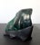 A malachite specimen with intense green and black colors fitted on a wood stand. The botryoidal form was polished in the...