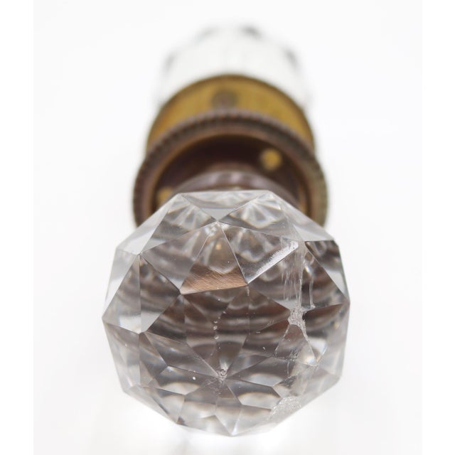 Faceted clear glass door knobs with a brass shank and rosettes. Good condition with appropriate wear from age. Priced as...