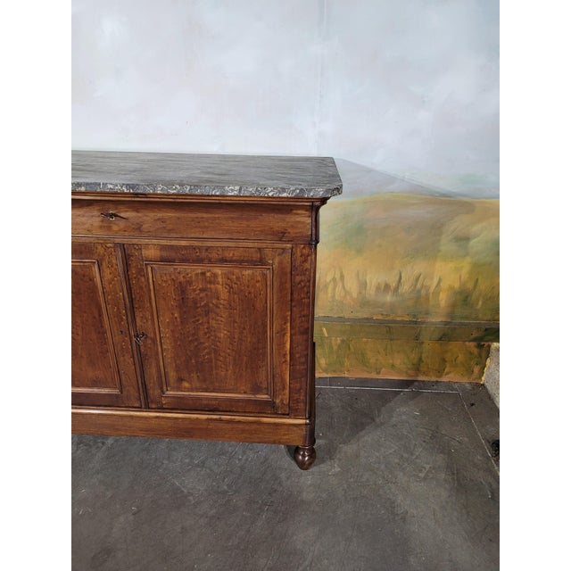 Small Louis-Philippe period mahogany sideboard with marble top This elegant small Louis-Philippe period sideboard is...