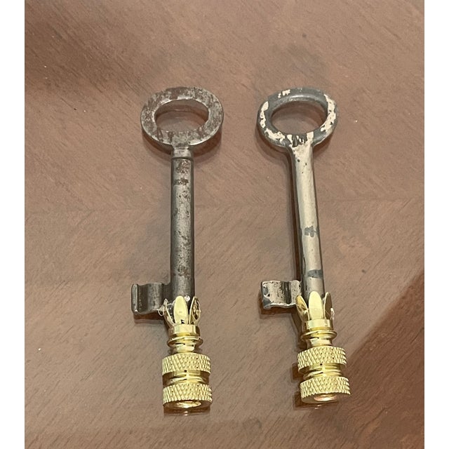 Vintage pair of skeleton keys mounted on brass bases as lamp finials.