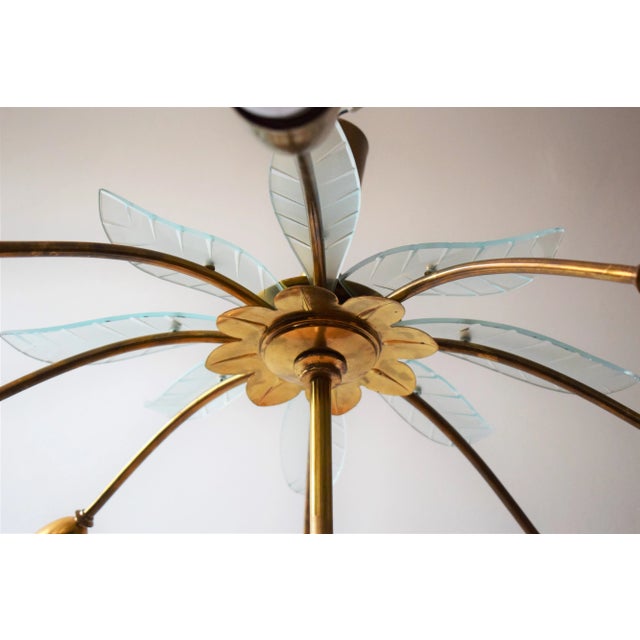 Large Italian ceiling lamp. 8 brass arms with Murano glass petals. Made for a theater in northern Italy. there are 2...