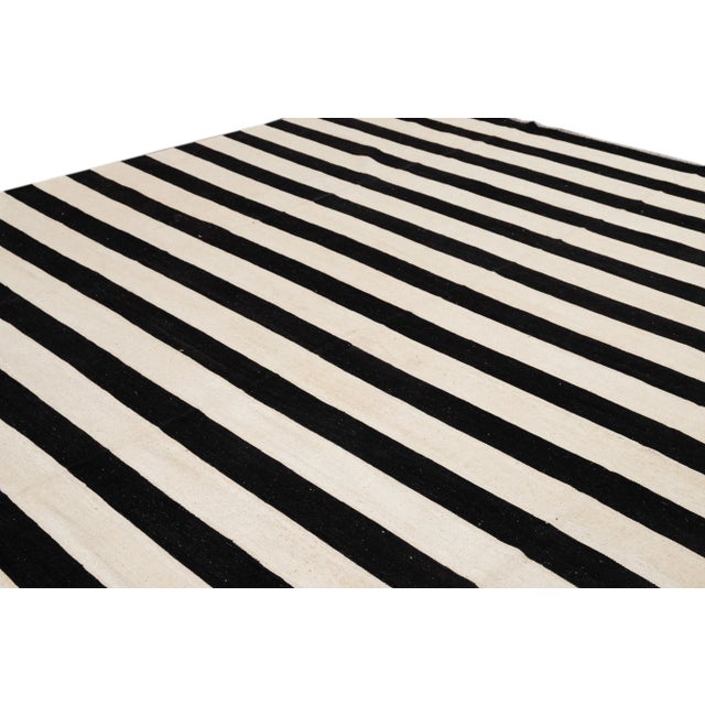 21st century contemporary striped black and white Kilim rug, measures: 12'1" x 15'0".