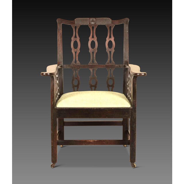 An unusual late 18th Century mahogany library armchair, with fluted top rail and central rosette, above sets of pierced...