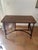 Vintage rattan and dark brown wood desk from the 1950s-1960s. Curved arches on the sides and a curved crossbar under the...