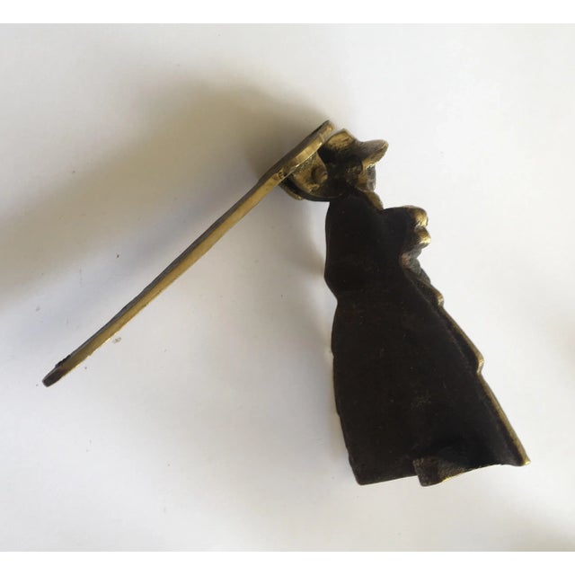 Southern Women Brass Door Knocker circa 1950. The women wear a large dress.