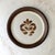 A set of four mid-century stoneware dinner plates featuring a hand-painted leaf design, made in Norway.