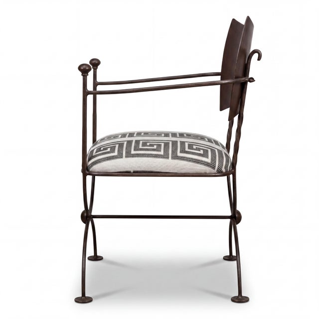 This is a pair of Italian hand hammered and forged steel campaign style arm chairs with new Greek key embroidered...