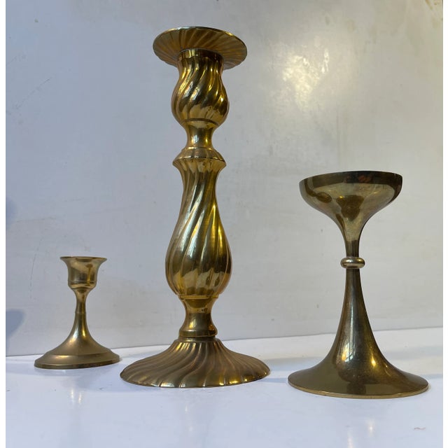 A trio of solid brass candlesticks manufactured in Scandinavia during the 1960s and 1970s. The candlesticks are to be...