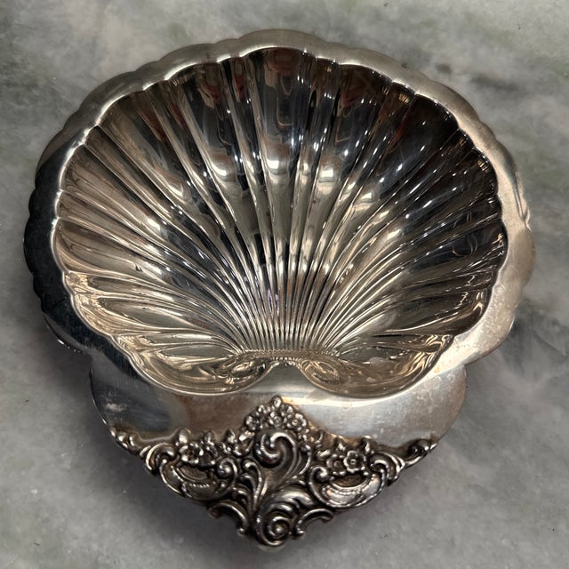 Beautiful mid-century silver plated shell dish. So shiny and a stunning way to present small collectibles.