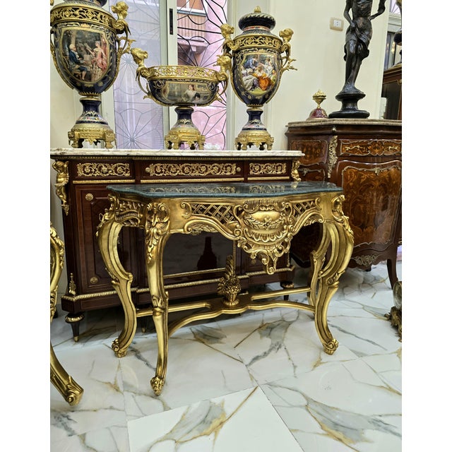 Beautiful large console table featuring a striking black marble top. Fully refinished in new gold leaf for a fresh,...