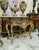 Beautiful large console table featuring a striking black marble top. Fully refinished in new gold leaf for a fresh,...