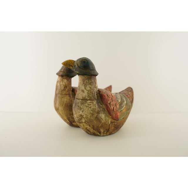 This pair of vintage bird figurines features detailed carving, textured surfaces, and colorful painted finishes that bring...