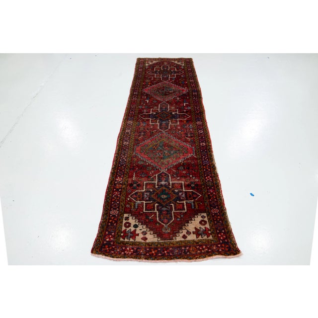 Beautiful vintage Heriz handmade wool rug with a red field and multicolor accents allover the tribal design. This rug...