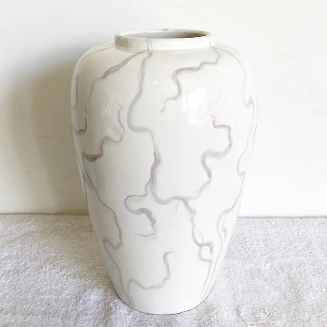 Wonderful vintage postmodern ceramic vase made in Italy. Features a cream glossy finish with purple, blue pink streaking...