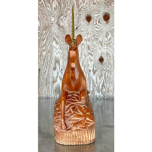 A fantastic vintage Boho unicorn. Chic hand carved wood with a twisted brass horn. Acquired from a Palm Beach estate.