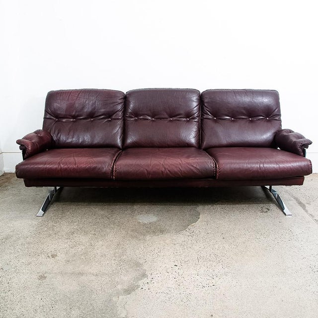 Rarely seen leather sofa designed Attributed to Arne Norell, This piece offers supple burgundy leather over solid metal /...