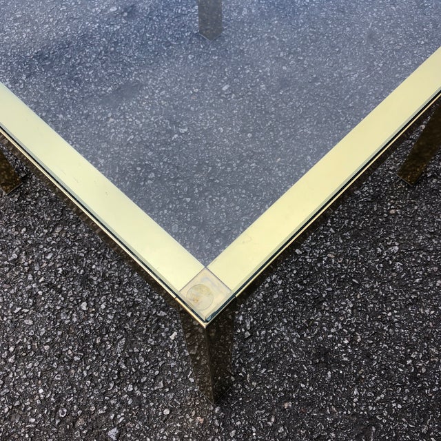 Beautiful brass side tables with heavy mid century glass top. Two pieces.