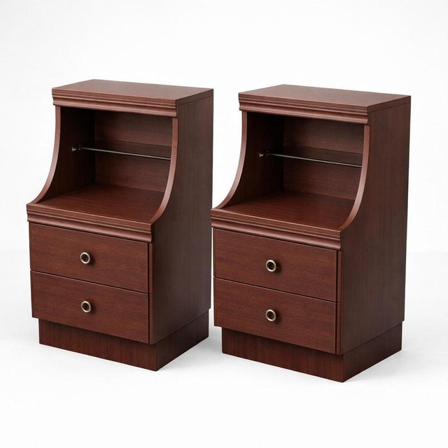 A stylish pair of vintage mahogany bedside cabinets, combining practical storage with a clean mid-century aesthetic. Each...