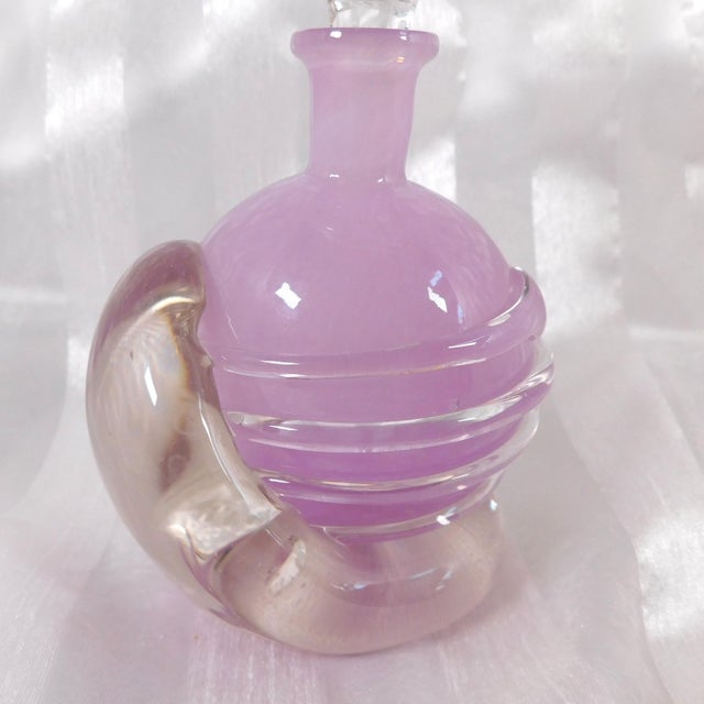 This is a pink Tamaian signed art glass perfume bottle that is a bit unusual. It is a pink color perfume bottle on and...