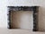 Antique French fireplace crafted from dark grey Gris des Pyrénées marble. This Louis XIV style mantelpiece possesses a...